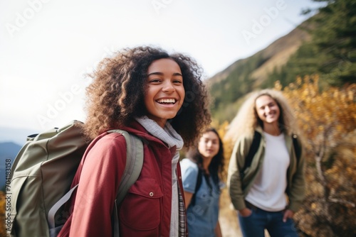 Three happy female friends hiking in the mountains
