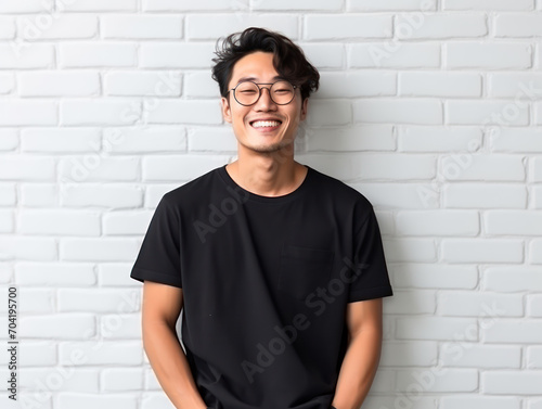 Portrait smiling Asian man wearing glasses and black t-shirt looking at camera,clothing mockup model