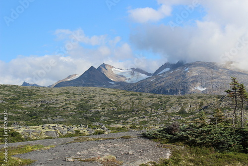 Clouds hanging over the top of rugged mountains in Southern Alaska