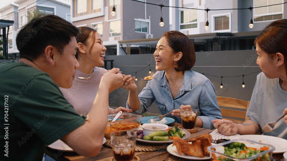 Mom enjoy thai meal cooking for family day meet talk home dining at dine table cozy patio. Group asia people young adult man woman friend fun joy relax warm night time picnic eat yummy food with mum.