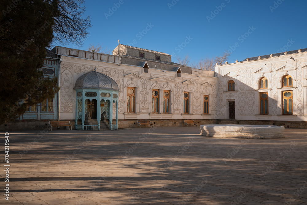 View of the building of the Sitorai Mokhi Khosa Palace, the country residence of the Emir of Bukhara and the courtyard with a fountain on a sunny day, Bukhara, Uzbekistan
