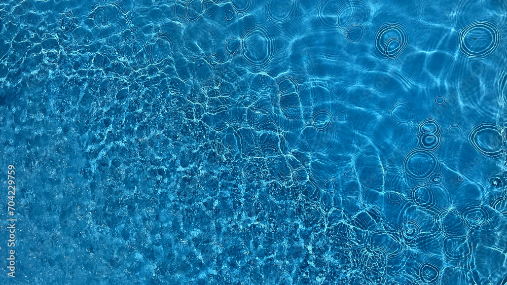 Crystal clear blue water surface with gentle ripples, suitable for concepts like tranquility, nature, or purity
