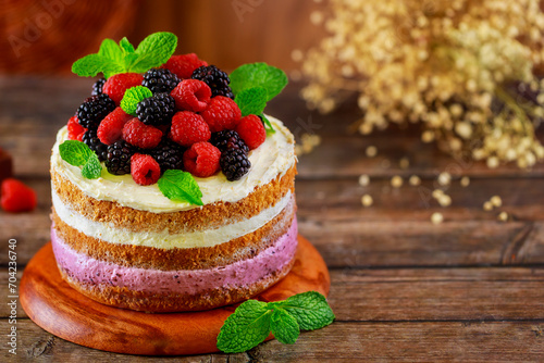 Fresh raspberries and blackberries are used to decorate this berry cake.