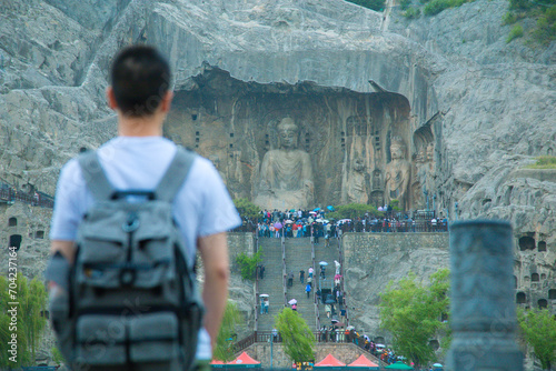 Luoyang City, Henan Province - Young people taking photos with Longmen Grottoes