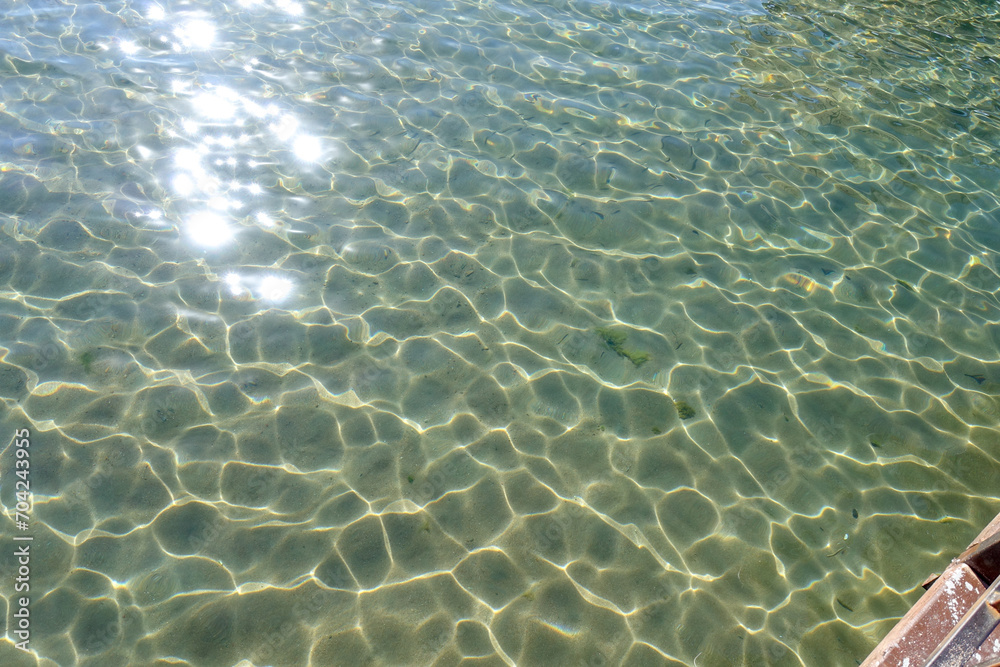 Fototapeta premium Clean transparent sea water, lake bottom and sand. Beautiful blue, turquoise transparent surface