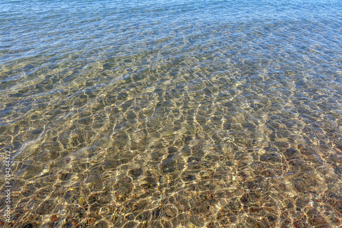 Clean transparent sea water, lake bottom and sand. Beautiful blue, turquoise transparent surface © Alwih