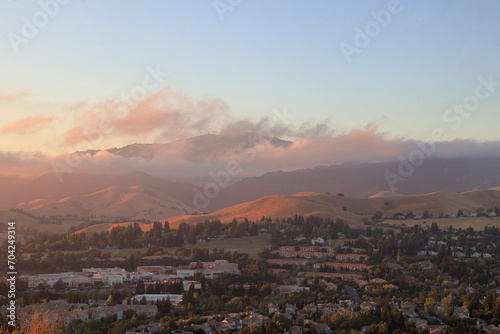 Fototapeta Naklejka Na Ścianę i Meble -  Marine layer low clouds moving over the slopes of Mt Diablo in the East Bay at sunset