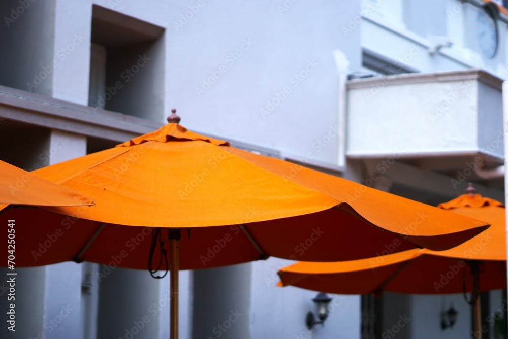Orange umbrella at an outdoor cafe at summer