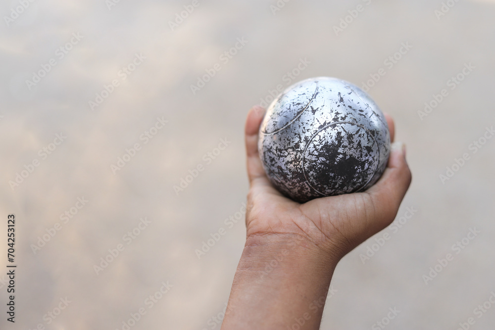 Kid hand hold Petanque in playing sport in free time for learning Kid hand hold Petanque in playing sport in free time for learning