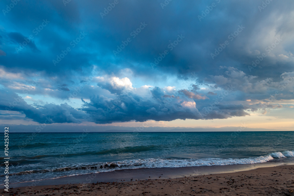 Colorful sunset on the sea. Mountain lake in the rays of the orange sun. Kyrgyzstan, Lake Issyk-Kul. natural background