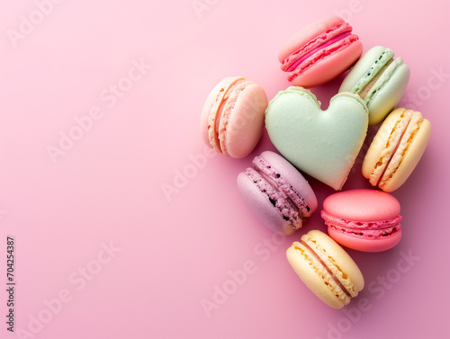 Top view of sweet macaron in heart shape with copy space on pink background, love and valentines day concept