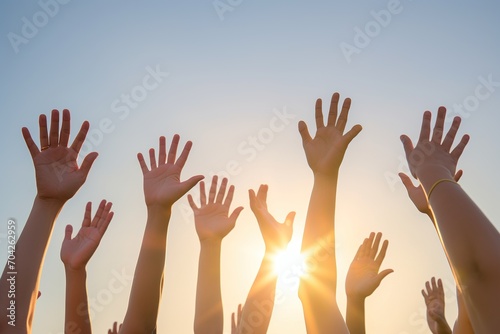 People raising their hands in the air photo