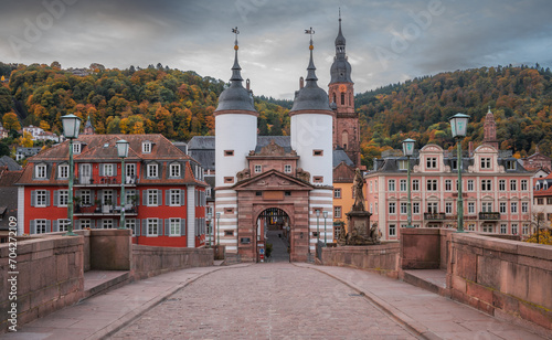 Early morning view of the old gate an the old bridge (Karl-Theodor-Brücke) during a cloudy morning. Famous touristic landmark. Travel theme. Germany.