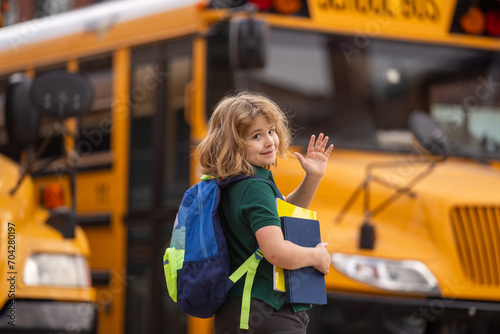 Pupil with backpack and book getting on the school bus. American School. Back to school. Bye bye. Kid of primary school. Happy children ready to study.