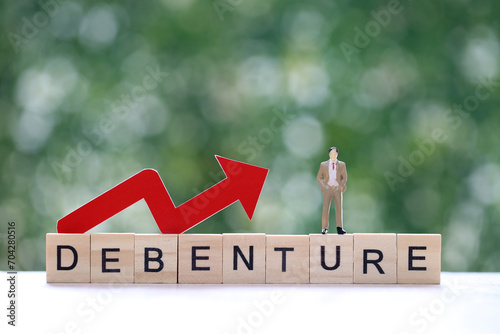Businessman on debenture word with red arrow graph on natural green background, Investments and Debenture concept photo