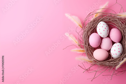Easter holiday celebration banner greeting card with pastel painted eggs in bird nest on bright pink backround tabel texture.. Top view, flat lay with copy space