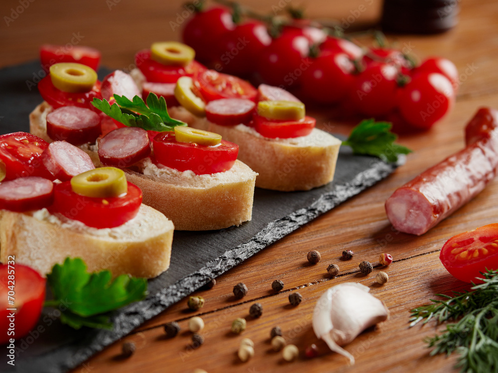 Bruschetta with tomatoes, mozzarella cheese and basil on a cutting board. Traditional italian appetizer or snack, antipasto. Top view with copy space. 