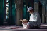Close up a muslim old man read the holy quran inside mosque in Ramadan month with islamic theme and sunset morning.