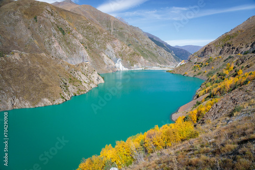 Tranquil Blue Reservoir Amidst the Serene Mountain Landscape with Lush Vegetation © ЮРИЙ ПОЗДНИКОВ