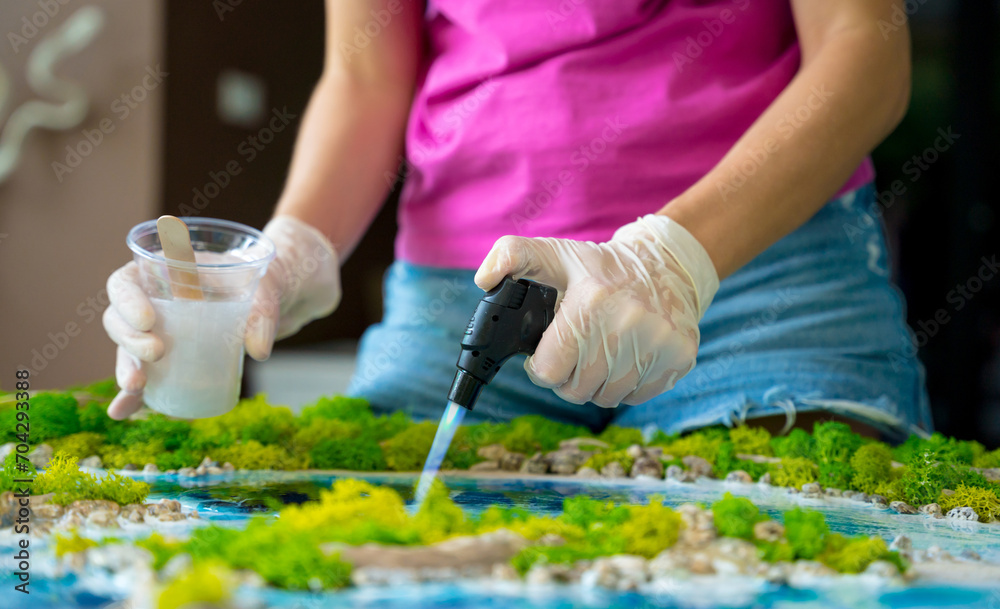 The process of making the art decor of epoxy resin, natural stones and moss The process of making the art decor of epoxy resin, natural stones and moss