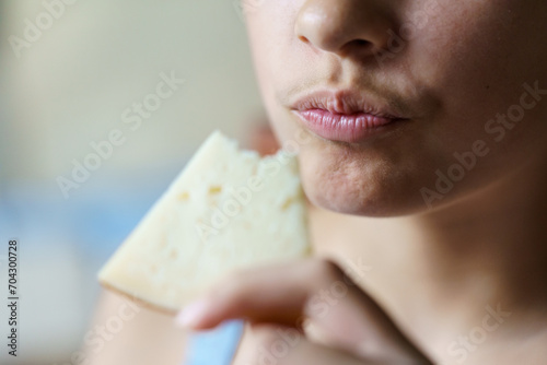Obraz na plátně Crop teenage girl holding eaten cheese slice at home