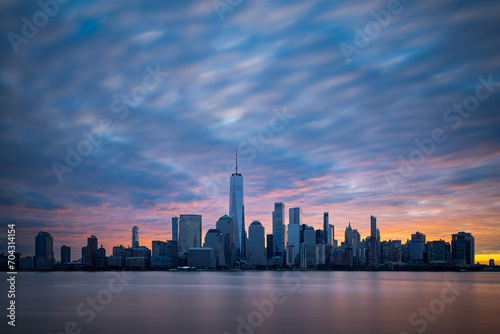 Morning atmosphere with colorful sky above Lower Manhattan cityscape. New York panorama as captured from New Jersey.