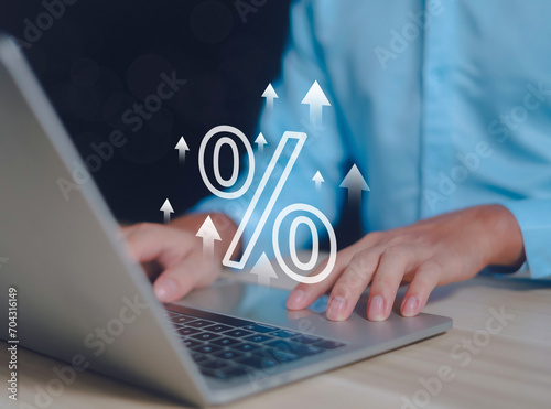 Businessman holding percentage sign in hand showing discount interest rate for commercial investment. To calculate business tax rates on a gray background.