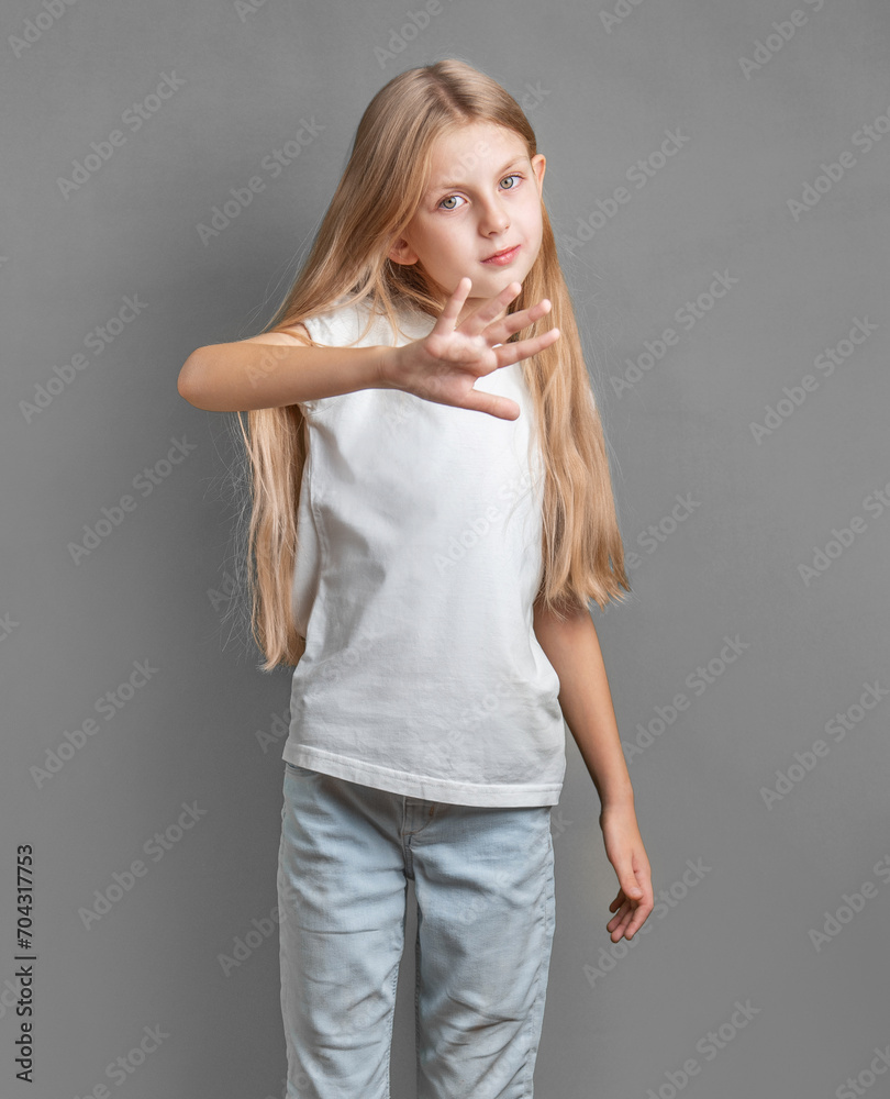 A little girl showing a sign of protest or refusal with her hand. A little girl showing a sign of protest or refusal with her hand.