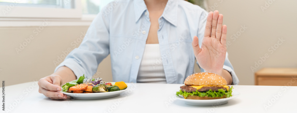 Woman on dieting for good health concept. Woman doing cross arms sign to refuse junk food or fast food hamburger that have many fat.