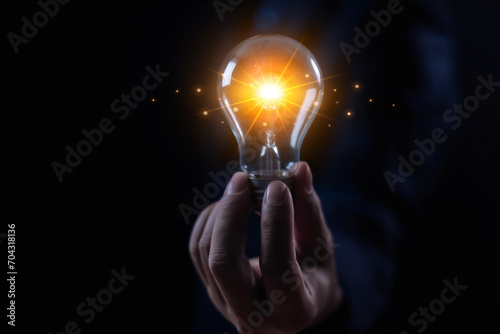 businessman holding a light bulb Creativity and imagination, ideas, knowledge, and design information in technology research Graphic and Intellectual Property Strategy for Competitive Businesses
