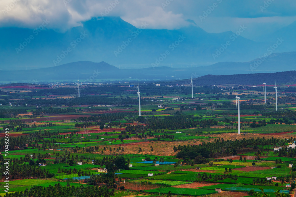 Windmill - Wind turbine installed on the mountain and agriculture land. Arial view of wind trbing farm, Alternate energy source generator with environment friendly.