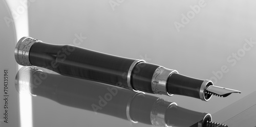 Fountain pen on glass table top. Dlack and White. 3D Render. photo