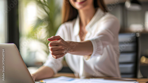 Happy businesswoman in office. Portrait of beautiful businesswoman offering hand for handshake.
