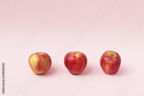 Red apples on pink background. Minimal food concept.