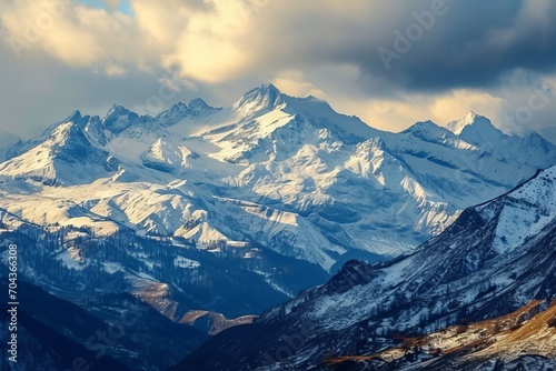 Snow-capped mountain peaks framed by heavy clouds. The concept for the development of tourism  mountaineering  skiing  rock climbing  excursions in the mountains.