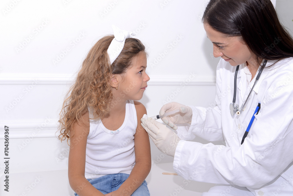 Child of preschool age receives a vaccine in the doctor's office Child of preschool age receives a vaccine in the doctor's office