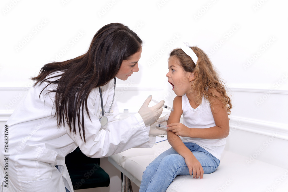 Vaccine fear in children, Little girl in face mask in doctor's office is vaccinated. Crying, scared, afraid of syringe with vaccine  coronavirus ,flu, infectious diseases .Clinical trials of injection