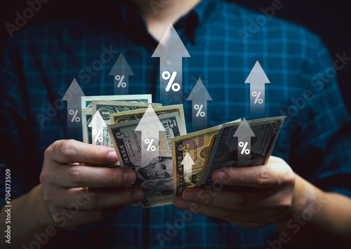 Businessman holding  USD dollar banknote with up arrow and percentage sign for increase interest financial banking and business profit dividend growth concept.