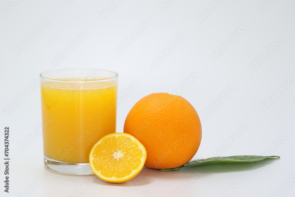 glass of orange juice and orange on white background glass of orange juice and orange on white background