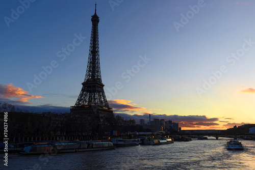 View of Eiffel Tower and river Seine at sunset in Paris. Eiffel Tower is one of the most iconic landmarks of Paris