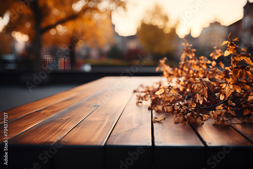 The empty wooden table top with blur background of european street in autumn