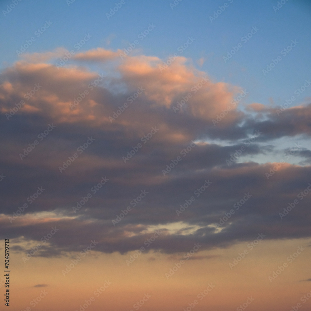 A serene sky with gentle clouds, illuminated by the fading sunlight. A serene sky with gentle clouds, illuminated by the fading sunlight.