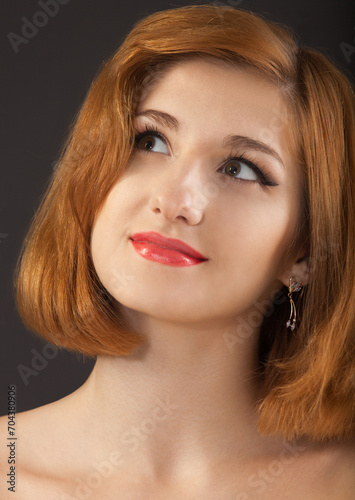 Beautiful young woman with red hair
