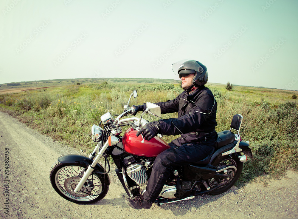 Obraz premium Biker on the country road