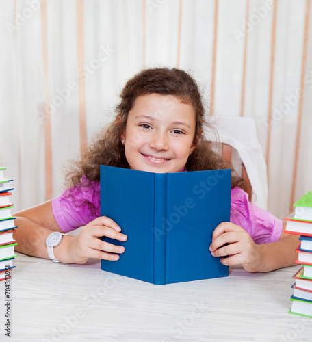 Little girl with piles of books