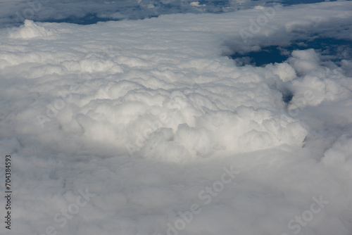 View of magnificent clouds and sky from above from an airplane.