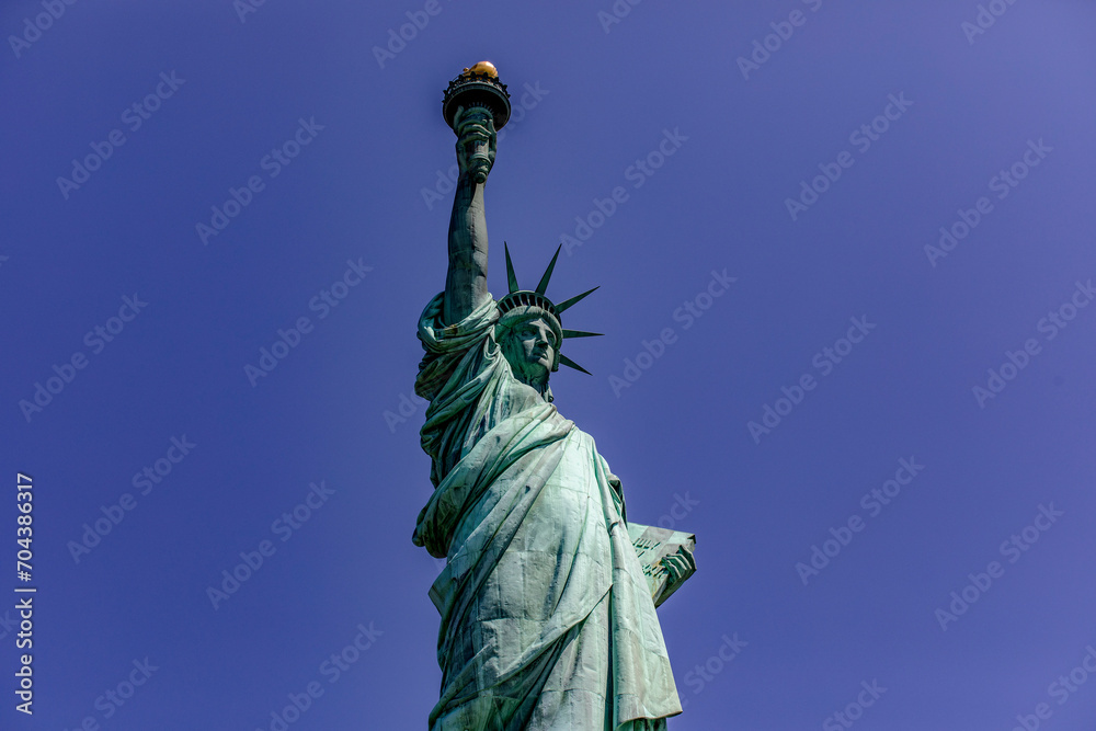 Fototapeta premium The Statue of Liberty with her crown holding her torch, democratic symbol of New York (USA) and the Big Apple, famous in Manhattan and the world.