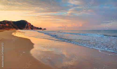 Fototapeta Naklejka Na Ścianę i Meble -  Beach of Cleopatra with sea and rocks of Alanya peninsula at sunset - Antalya, Turkey 