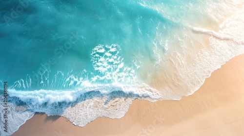 Sand beach from above with light blue water wave and sun lights