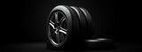 Black and grey car tire on a black background